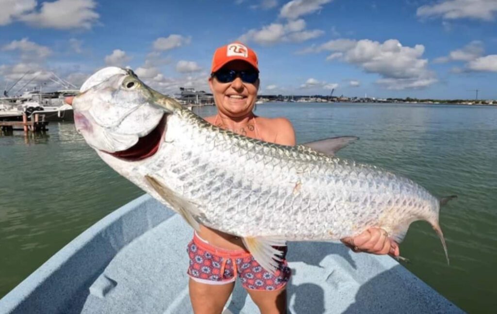 Bailey holding a large fish.