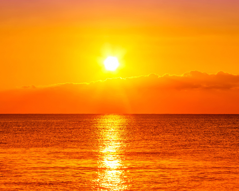 Ocean waters with sunset in background.